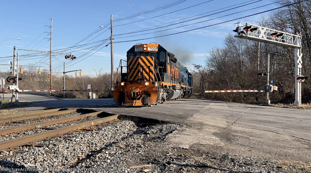 WE 7001 reappears on track 2, now heading west.